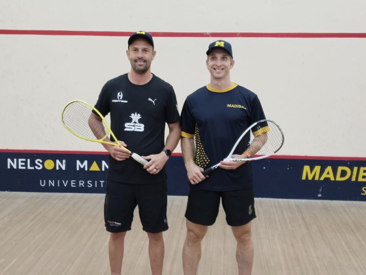 Madibaz Open squash tournament winner Rudi van Niekerk and tournament director Jason le Roux.